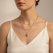 Woman wearing layered gold necklace